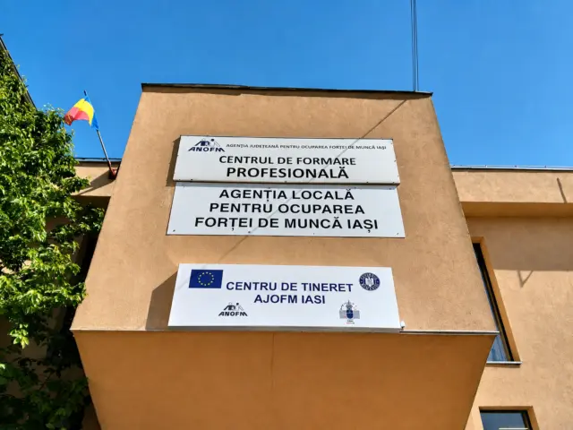 AJOFM Iași facade signs identifying the vocational training centre, local employment agency and youth centre.
