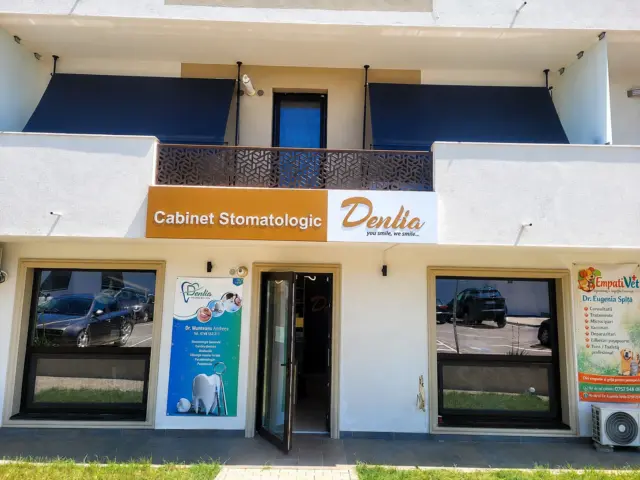 Dentia sign with raised lettering and logo mounted above the dental clinic entrance.