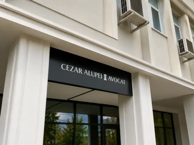 Cezar Alupei Avocat sign with white lettering on a black panel above the entrance.